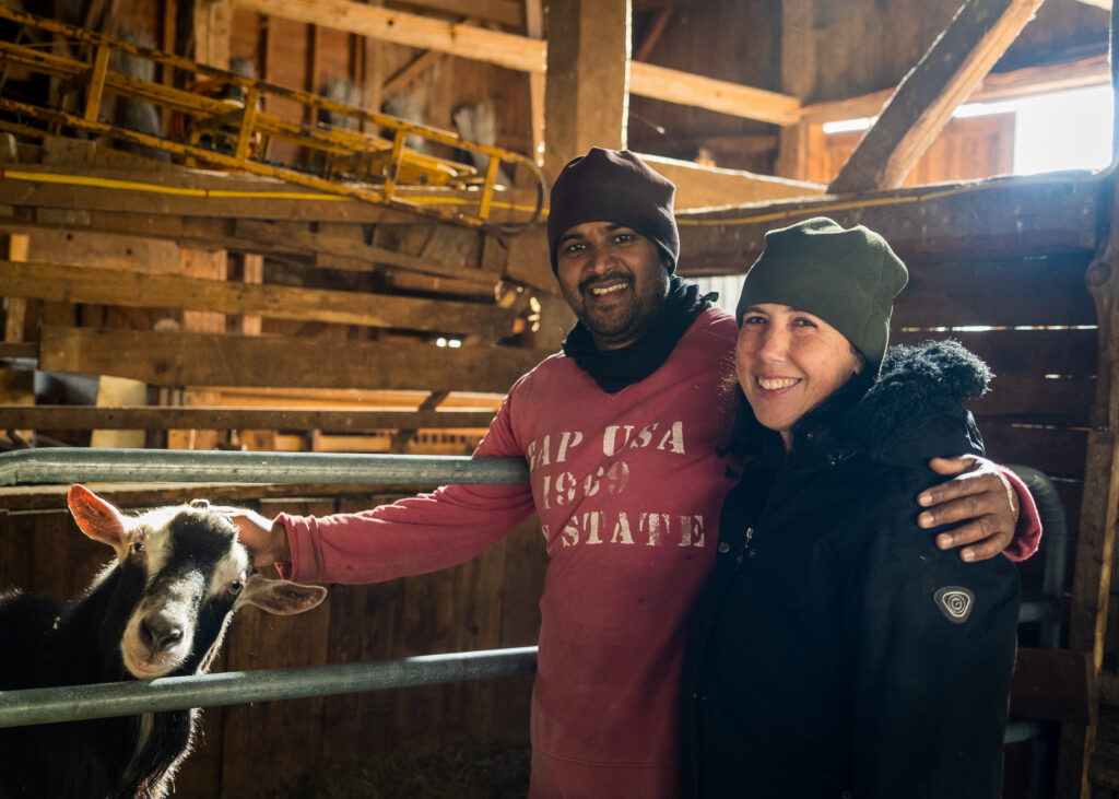 Anil Roopchand and Kelly Payson-Roopchand with a goat