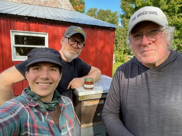  Bruce Collins, Adam Foster Collins, and Bianca Braman with a jar of honey